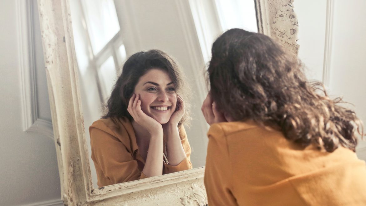photo of woman looking at the mirror 774866
