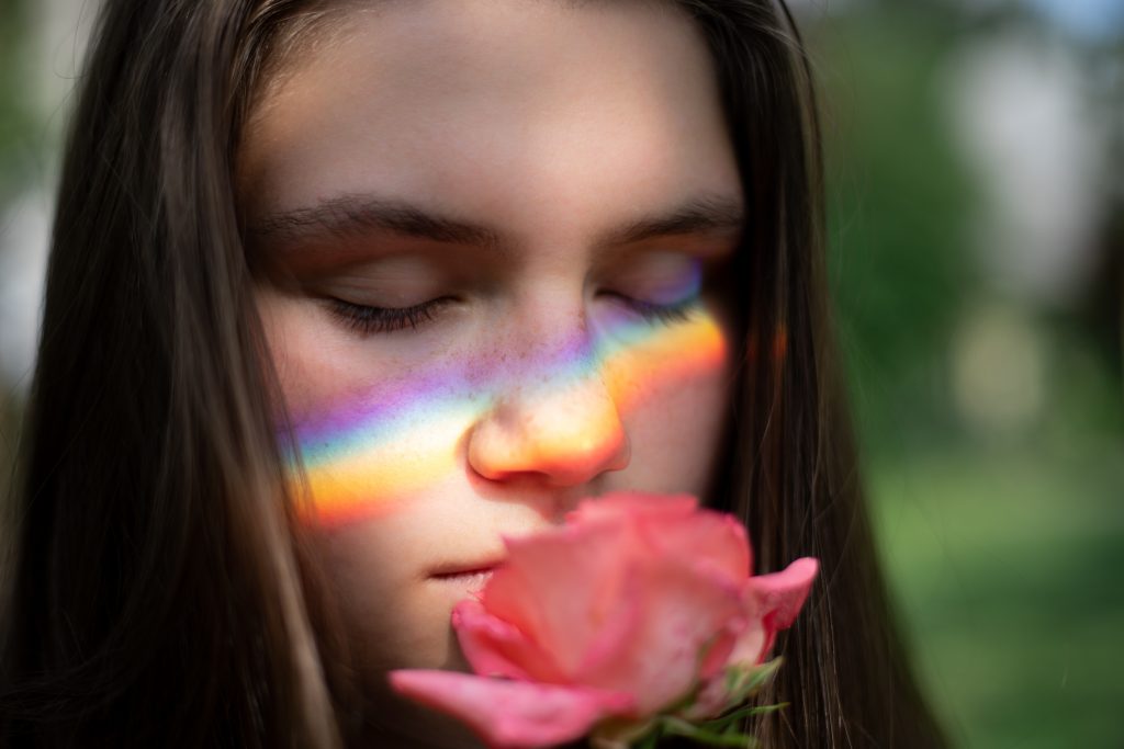 close up photography of woman smelling pink rose 1170654