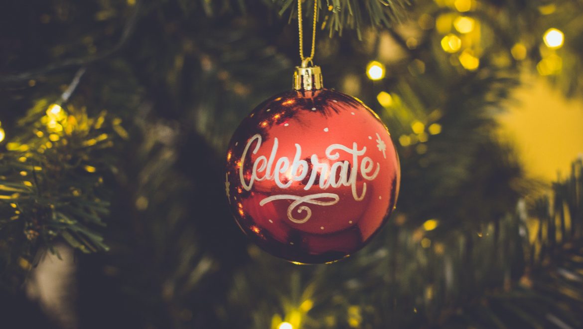 red celebrate print baubles hang on green christmas tree 714899