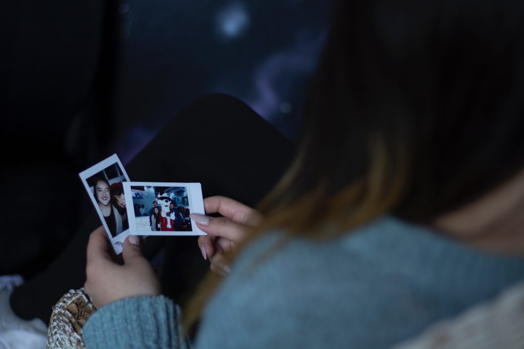 woman holding two photos 1538077