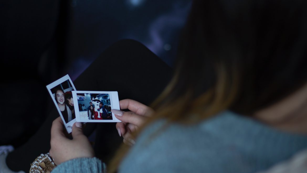 woman holding two photos 1538077
