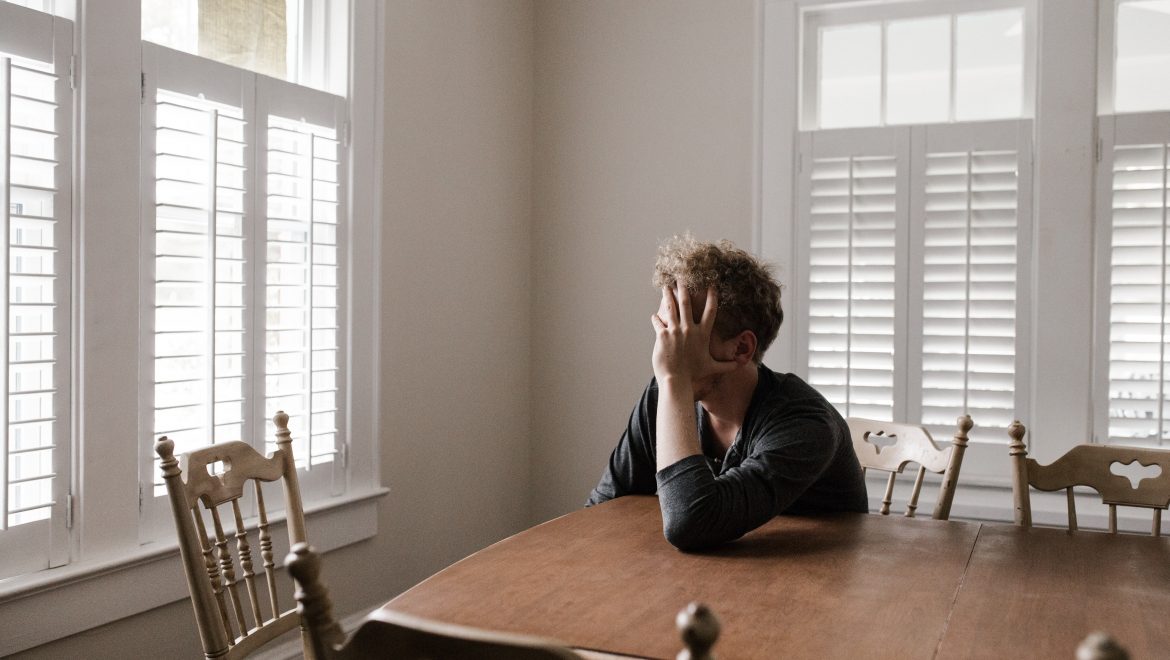 photo of man leaning on wooden table 3132388