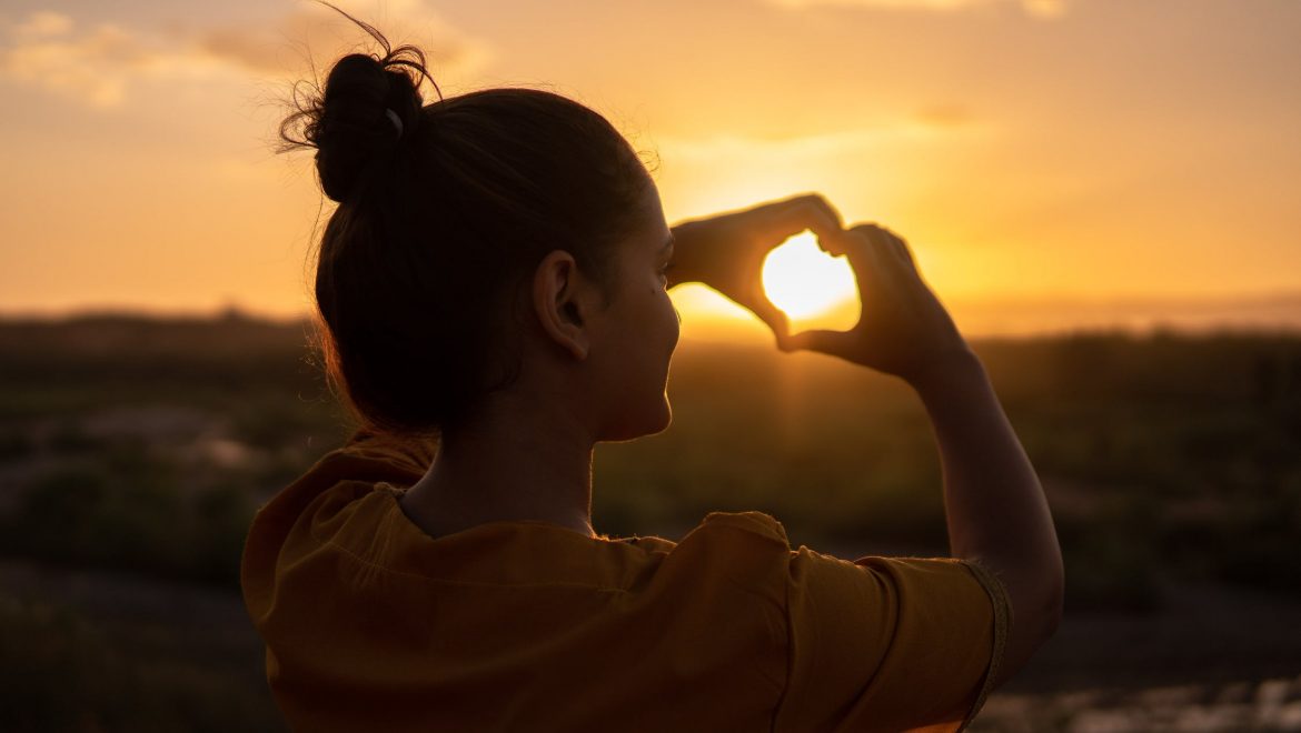 self compassion expat nest woman with heart hands Hassan Ouajbir Pexels